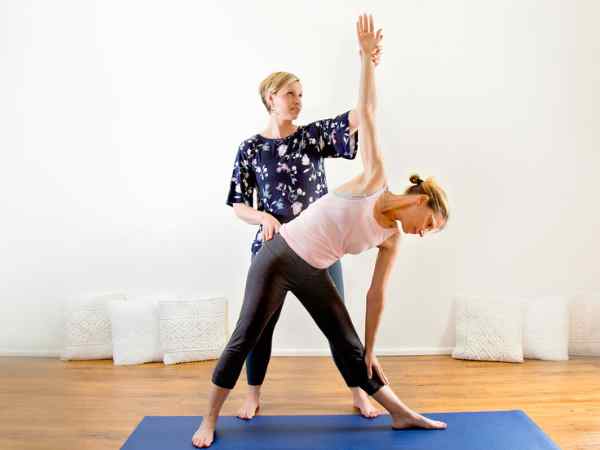 Instructor guiding a student in a private yoga session at Relax Yoga, Chermside